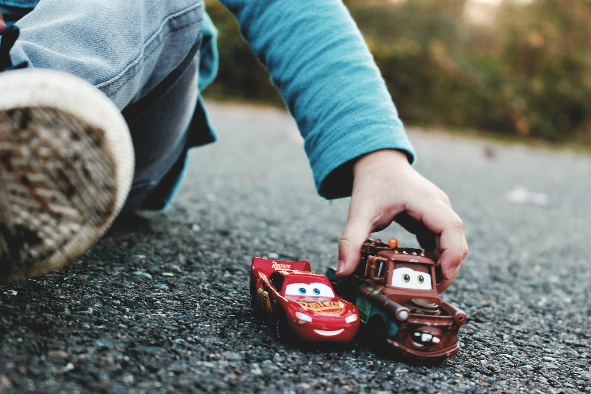 person holding red and black toy car